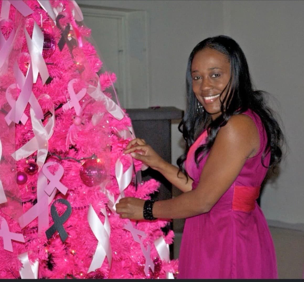 Standing with families at a breast cancer awareness event